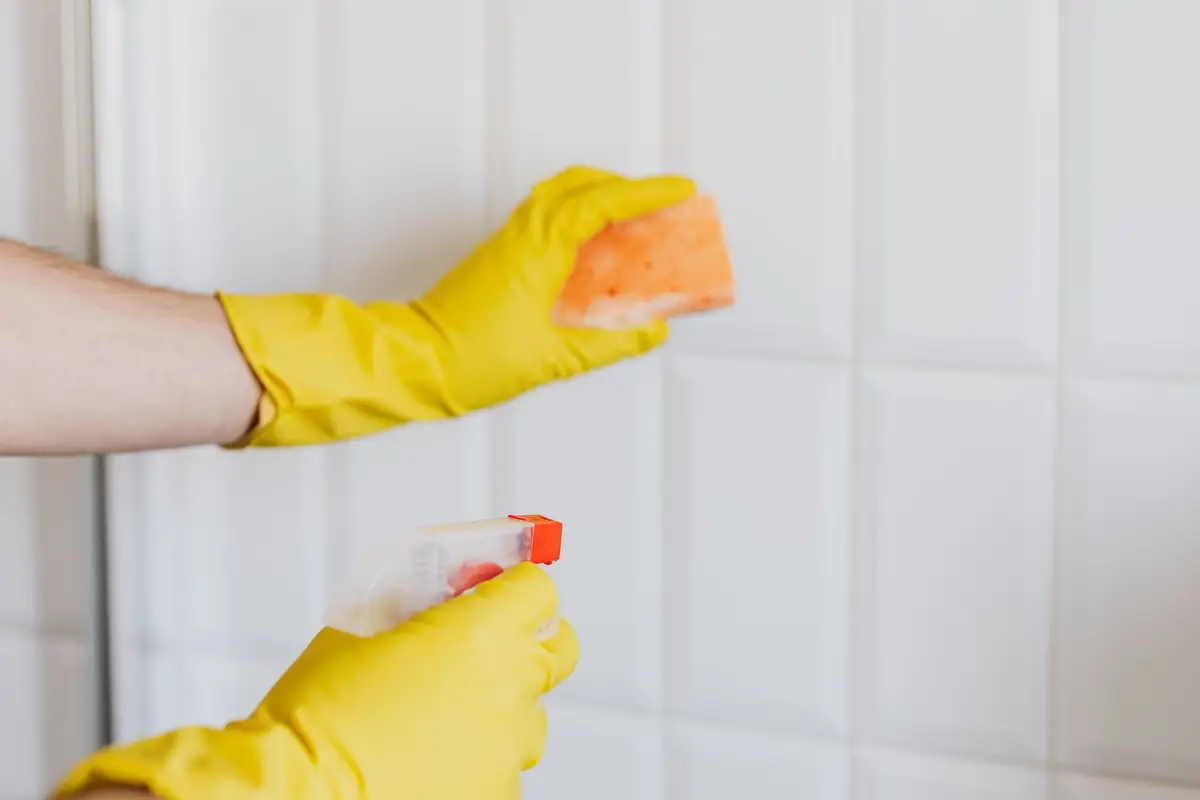 Cleaning franchise team member in branded uniform preparing equipment for a domestic clean