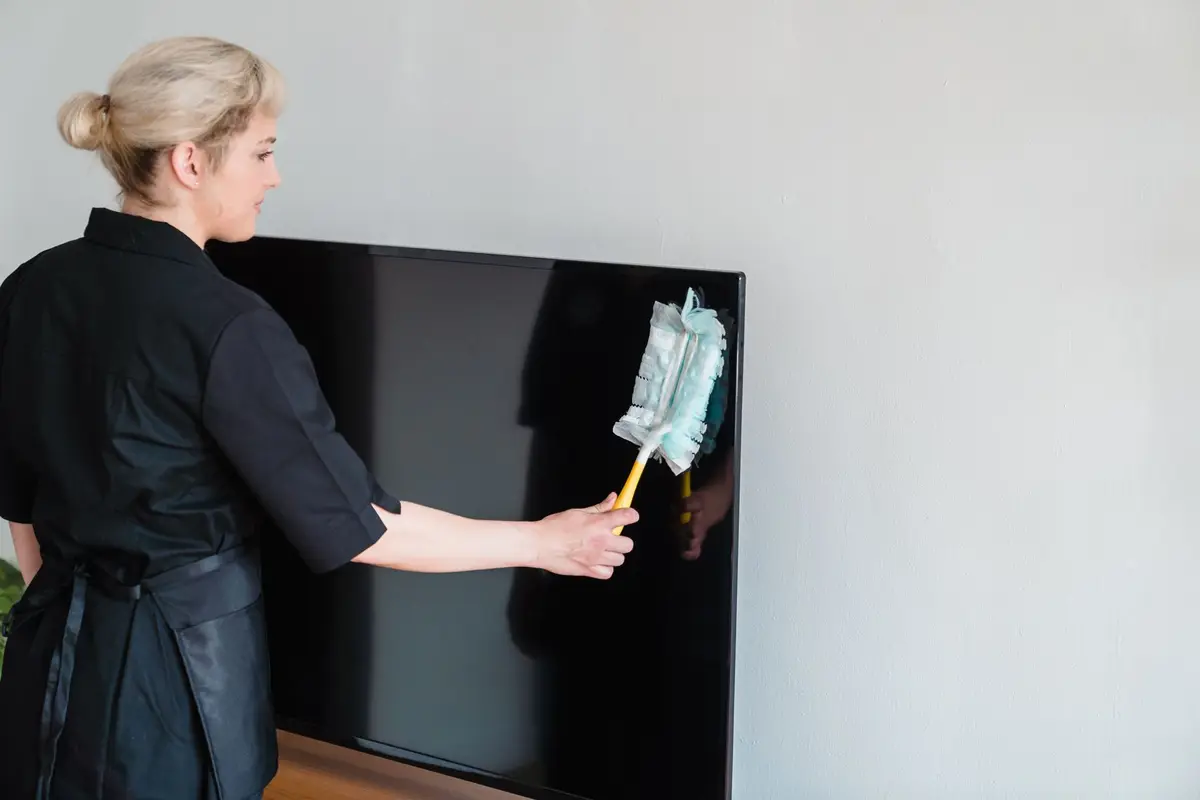 Franchise owner reviewing cleaning team schedule on a tablet in a modern office