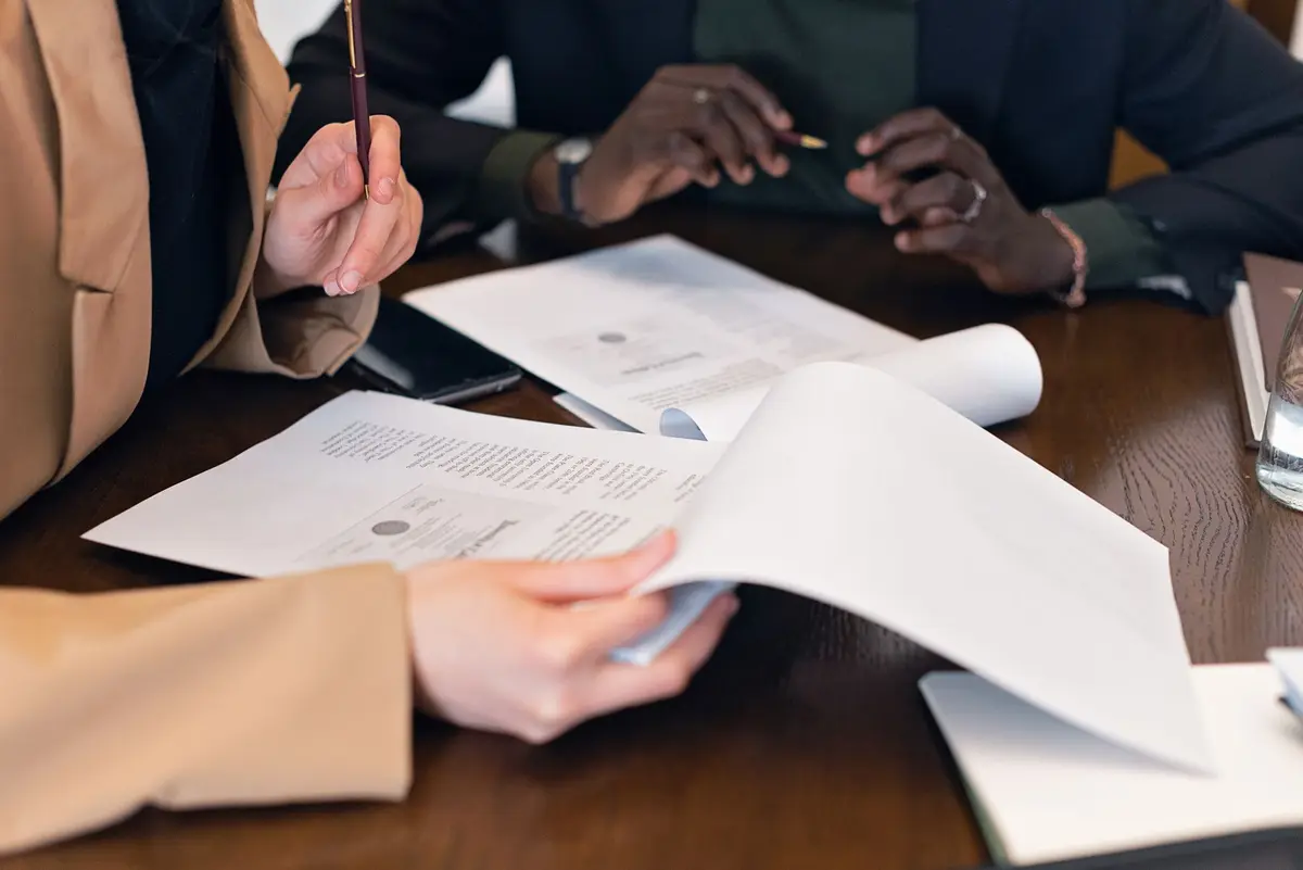 Person reviewing franchise documents and financial reports at a desk