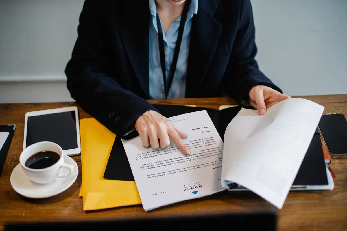 Two people reviewing a legal document in a meeting room setting