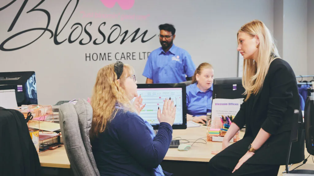 Blossom Home Care franchise office team discussing operations