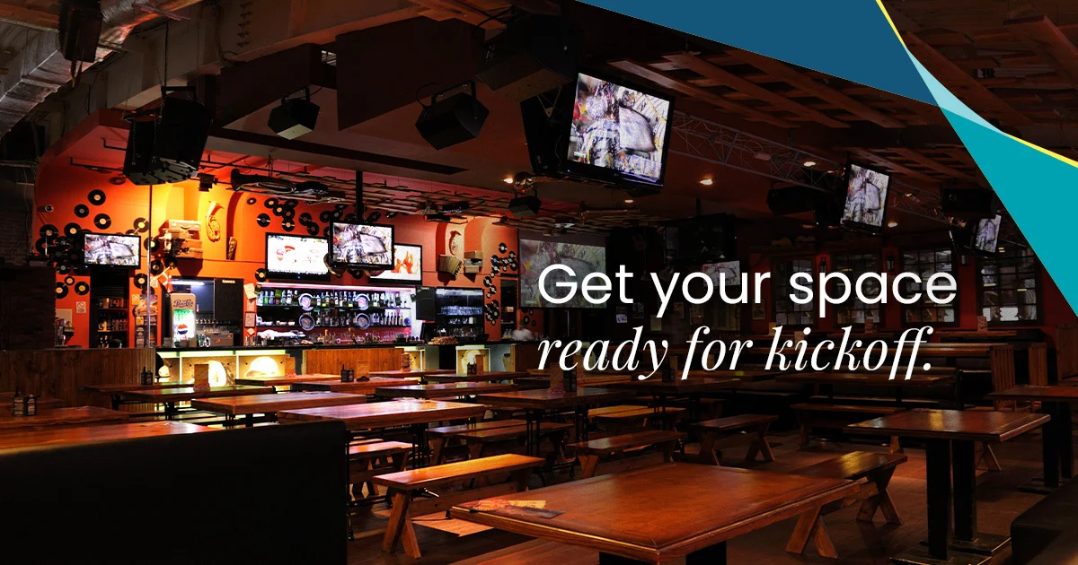 ServiceMaster Clean 'Get your space ready for kickoff' seasonal marketing visual showing a sports bar interior with rows of TVs, hanging speakers and timber tables ready for service - example of the hospitality vertical the network cleans for