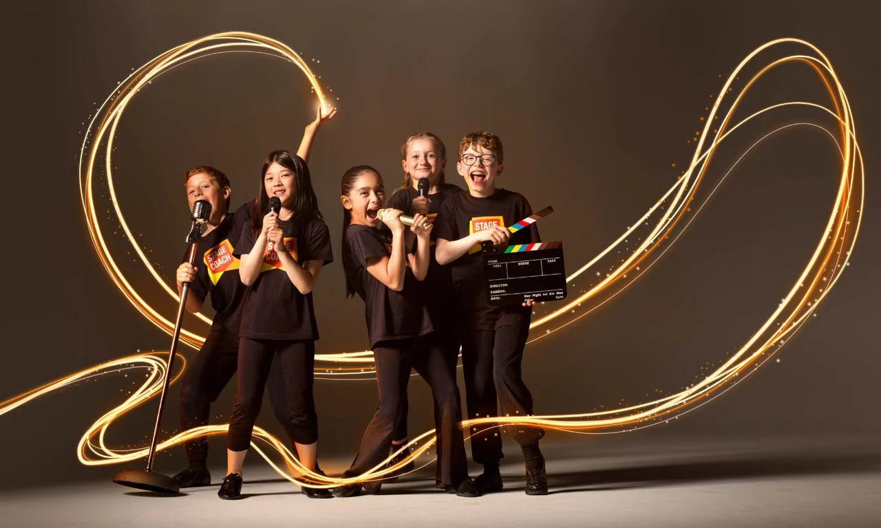 Five Stagecoach Performing Arts students in black tees with orange badge logos posing dramatically with microphones and a film clapperboard, surrounded by swirling gold light trails that suggest a sparkling stage performance