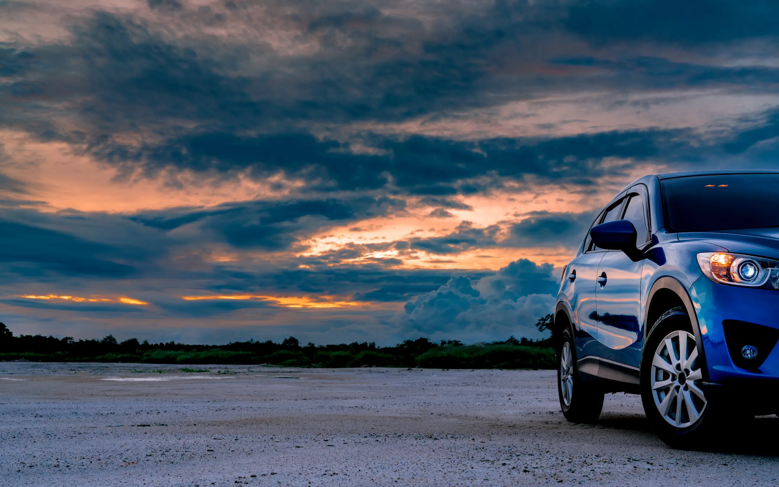 Automotive franchise opportunities in the UK represented by a modern SUV car against a scenic landscape