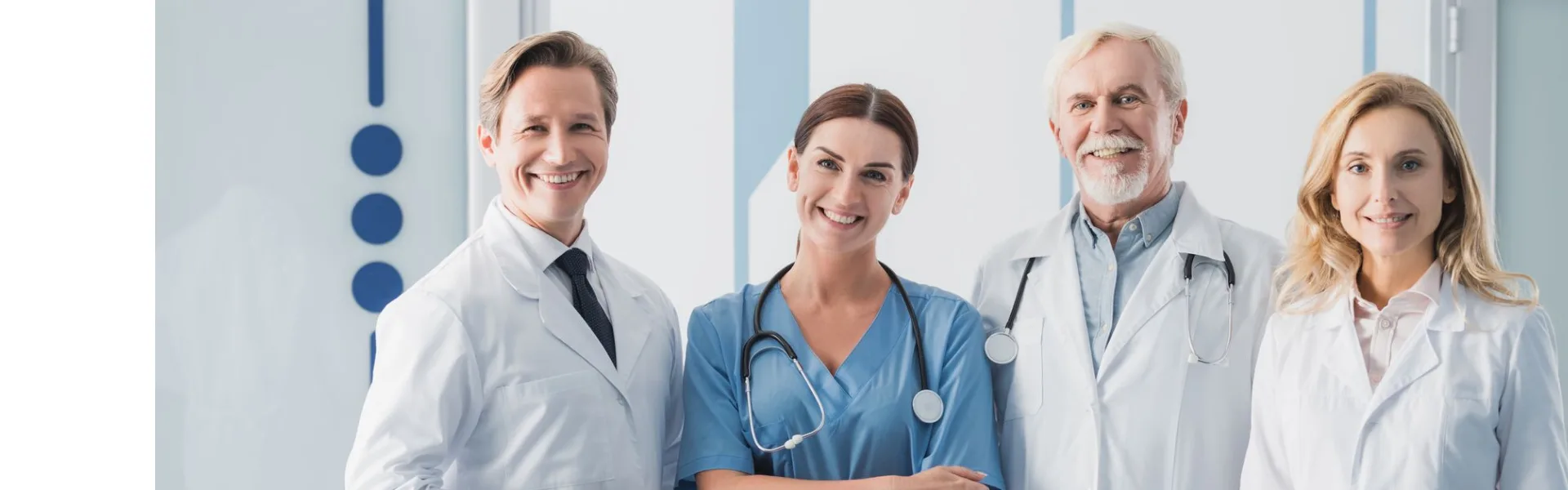 Smiling team of medical professionals in white coats and scrubs standing together in a modern clinic, representing health and beauty franchise opportunities in the UK.