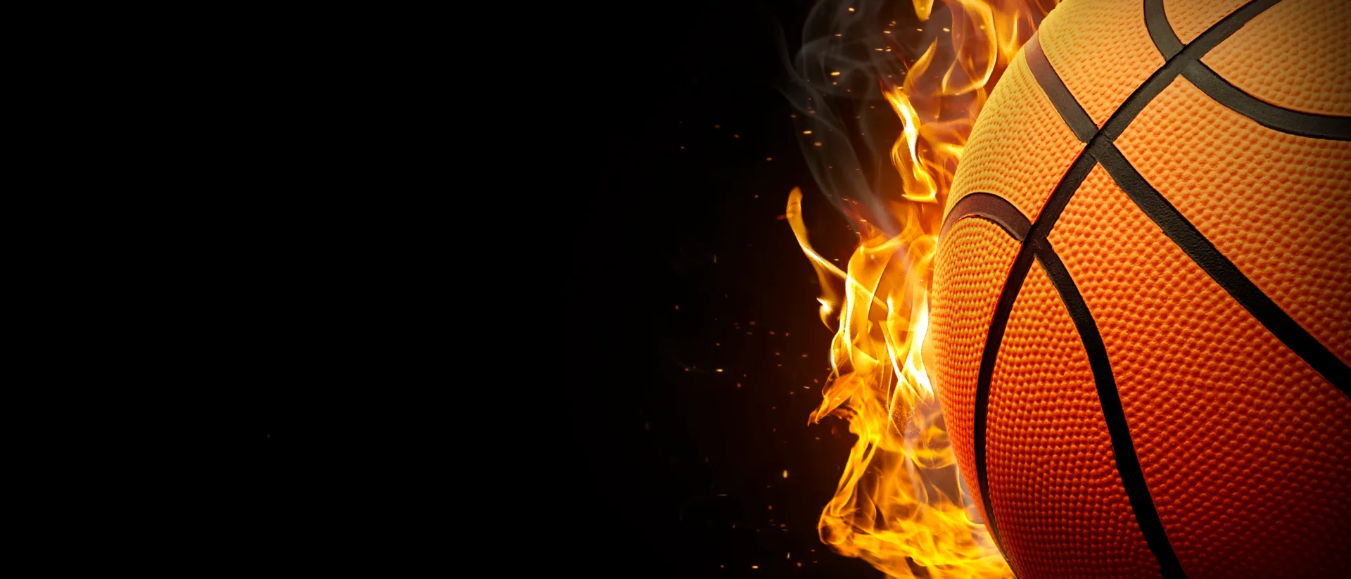 Close-up of a basketball engulfed in flames against a black background, representing sports franchise opportunities in the UK.